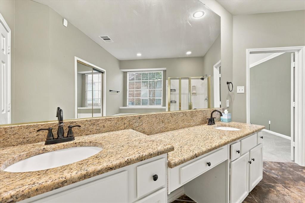 A TOUCH OF EVERYDAY INDULGENCE! Double sinks, beautiful granite countertops, stylish dark fixtures, and an oversized mirror offer generous personal space and classic sophistication.