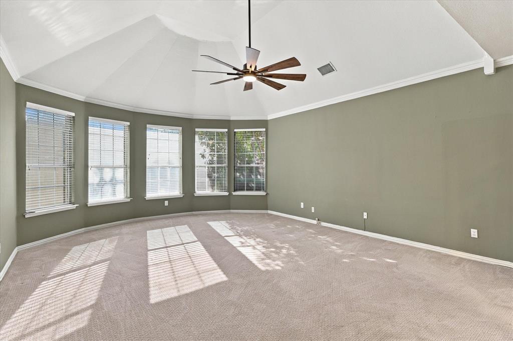 YOUR PRIVATE SANCTUARY AWAITS! This extraordinary primary bedroom features a dramatic vaulted ceiling, an elegant bay of five windows, a statement ceiling fan, and expansive proportions. A tranquil retreat designed for ultimate comfort and relaxation.