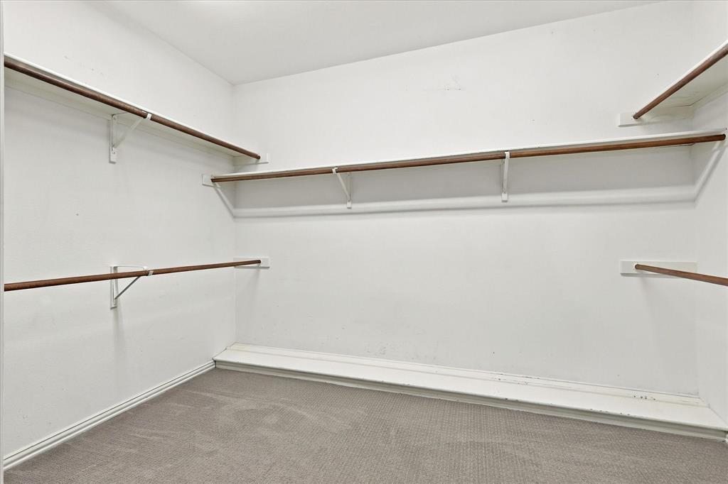 ROOM FOR A BEAUTIFULLY ORGANIZED WARDROBE! This spacious walk-in closet offers multiple hanging areas, convenient shelving, and generous storage possibilities to keep everything beautifully arranged.