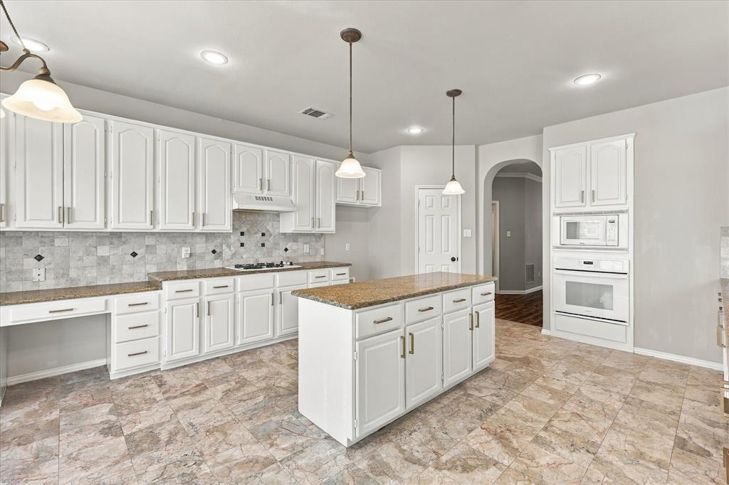 SPACE, STYLE, AND ENDLESS POTENTIAL! An expansive center island, abundant freshly paint white cabinetry, generous preparation space, and built-in appliances make this impressive kitchen ideal for everyday cooking and entertaining. Its open design keeps everyone connected to the home's spectacular living spaces.