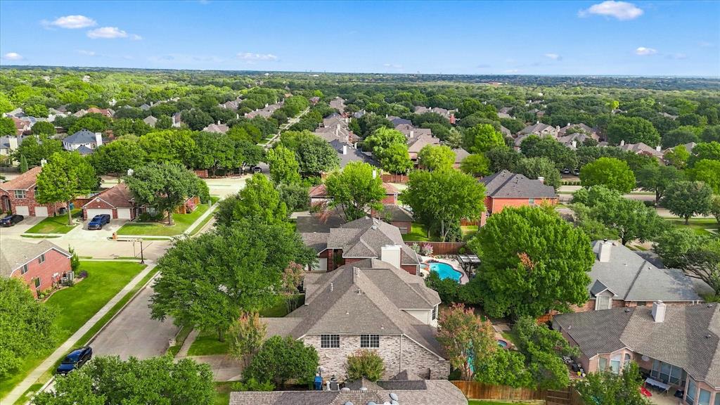 BEAUTY FROM EVERY ANGLE! Discover the charm of this tree-lined Flower Mound community from above, showcasing attractive homes, established landscaping, and an abundance of mature greenery.