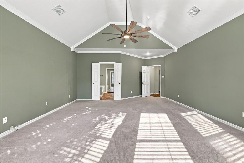 GRAND SCALE MEETS SERENE SOPHISTICATION! A magnificent vaulted ceiling with graceful architectural detailing, soft neutral finishes, and generous floor space creates an impressive primary retreat with an atmosphere of understated luxury.