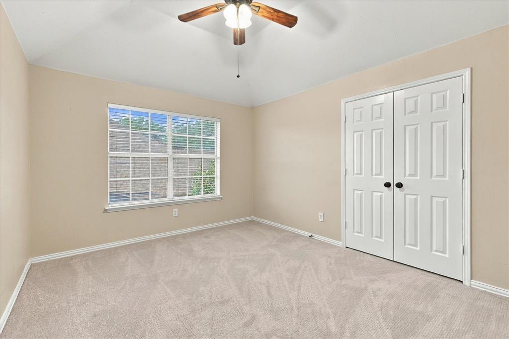 COMFORT, CHARM, AND NATURAL LIGHT! This spacious bedroom features plush new carpeting, a beautiful window overlooking the outdoors, a ceiling fan, and a generous double-door closet.