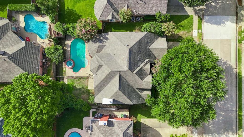 A bird’s-eye perspective highlights the home’s private backyard oasis, complete with a sparkling pool, spa and a beautifully tucked-away setting within the neighborhood.