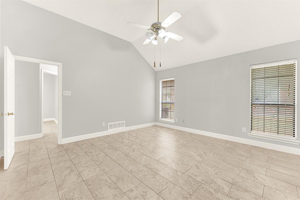 Clean neutral walls surround wide sightlines, enhancing the room's peaceful architectural symmetry. Imagine curling up with your favorite book in a cozy corner armchair during a quiet evening reset.