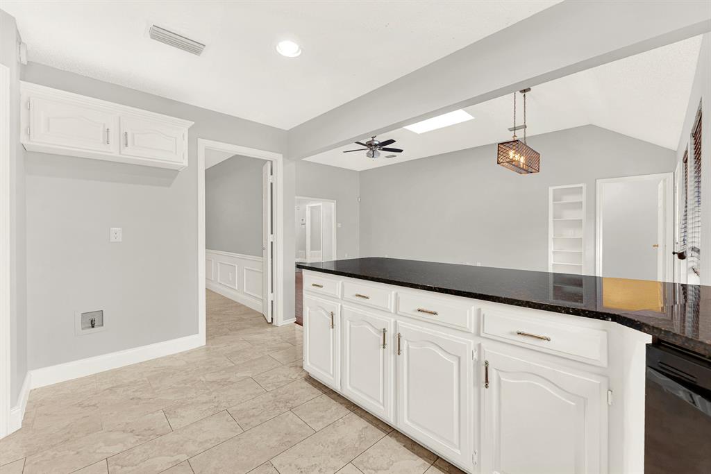 An expansive breakfast bar seamlessly bridges the cooking zone with adjacent living areas under high ceilings. Visualize family chatting over casual weeknight meals while prep work happens effortlessly nearby