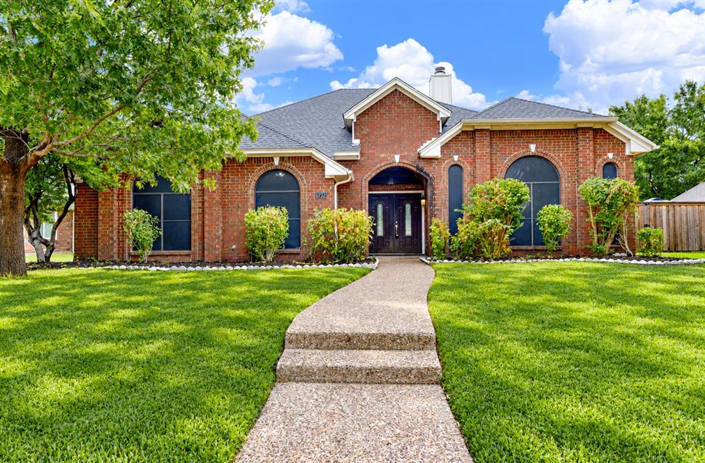 *digitally enhanced*  A grand arched brick entryway anchors the classic red brick exterior, framed by large arched windows and a pebbled pathway that leads straight to the front door. Picture pulling into the driveway after a long day and feeling an instant sense of pride as you walk up to your welcoming home.