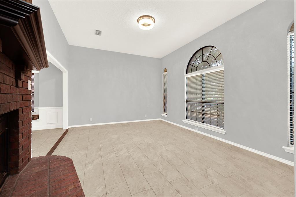 Soaring ceilings and arched windows flood this airy space with soft, natural light. Picture sipping a warm morning coffee here while sunlight streams through the glass to start your day