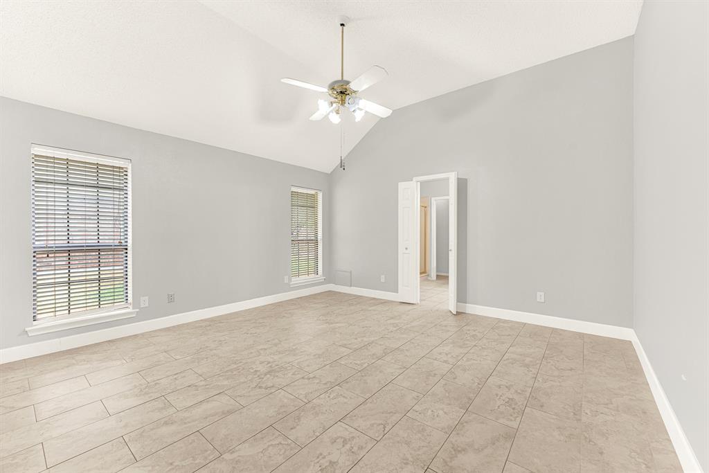 A dramatic vaulted ceiling rises above smooth tile floors, giving this spacious retreat a light and airy dimension. Picture waking up to soft morning rays filtering through double windows as you begin your day.