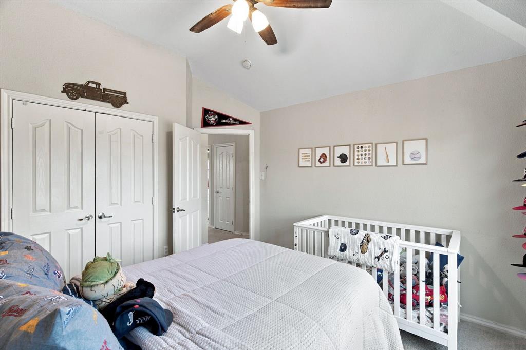 Vaulted ceiling featuring a central ceiling fan with integrated lighting, paired with double-panel closet doors