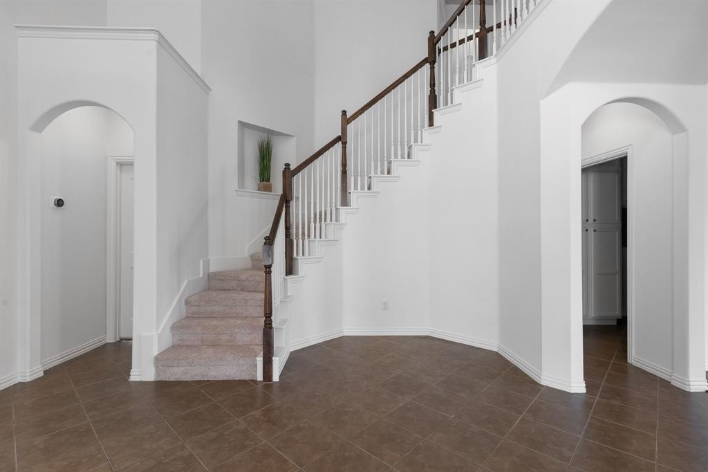 Grand staircase with wood-finish handrail and brand new carpeted