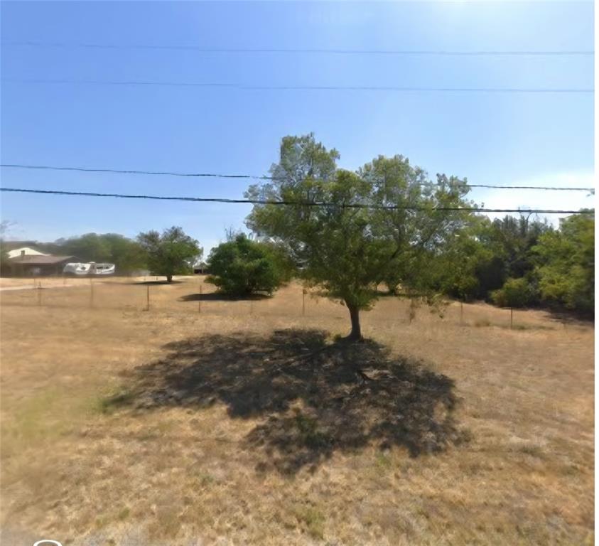 Expansive lot with mature trees and perimeter fencing