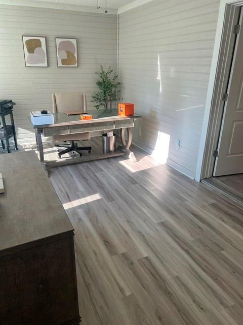 Multi-purpose room featuring shiplap-style walls, wood-finish flooring, and white baseboards