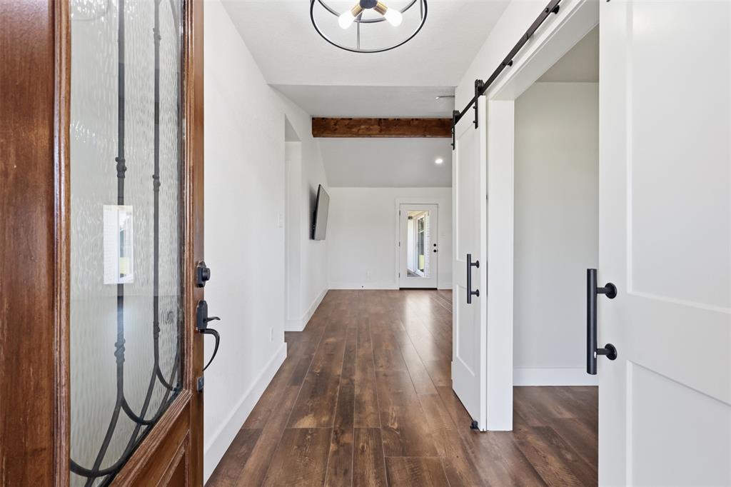 Front entrance with office or flex space on the right and living room straight ahead