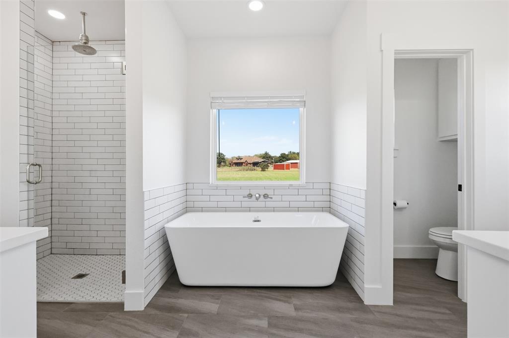 newly added primary bath with stand alone tub and walk in shower
