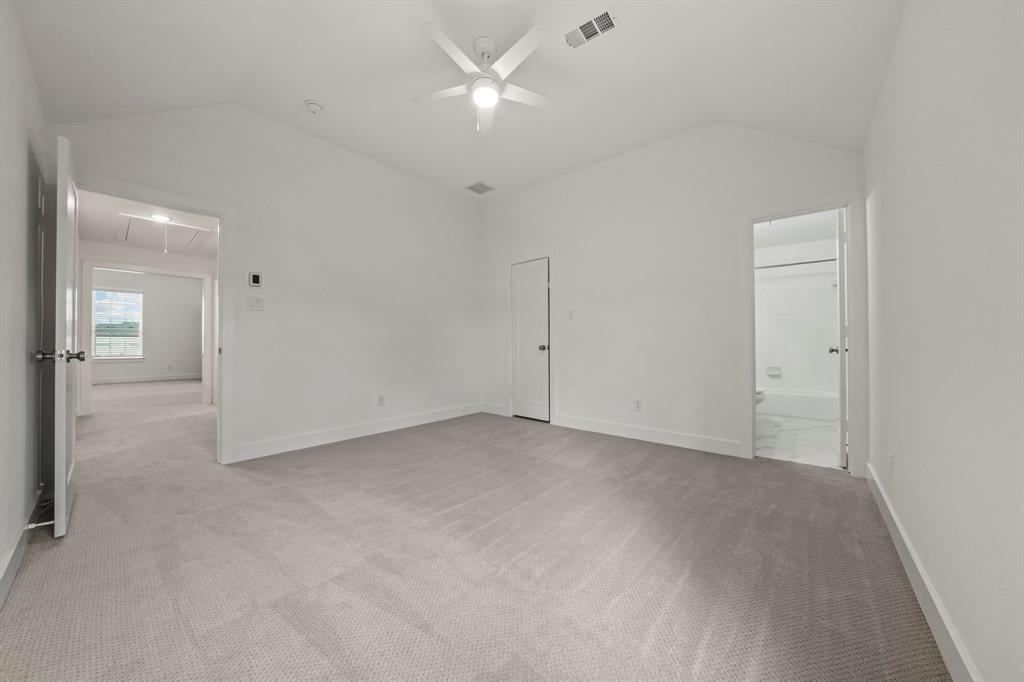 Vaulted ceiling with integrated multi-blade ceiling fan and wall-to-wall carpeting