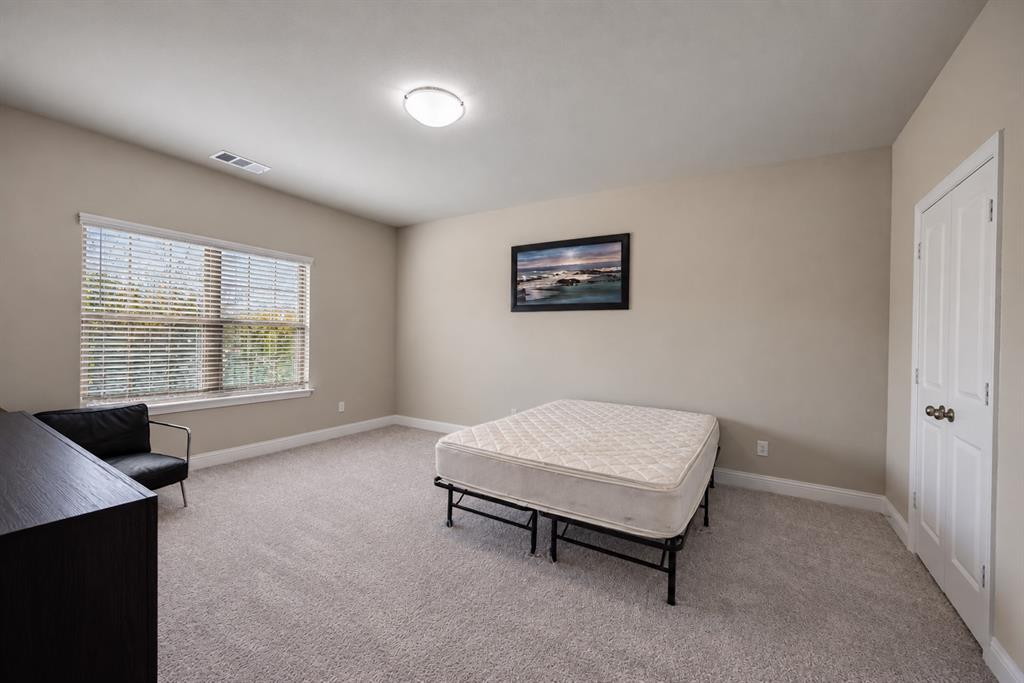 Wall-to-wall carpeting, window with blinds, recessed lighting, and a paneled door with dark hardware