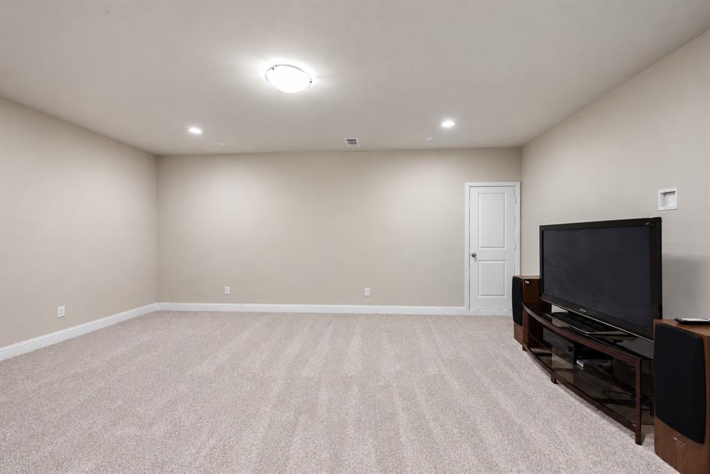 Recessed lighting, flush mount lighting, light beige carpeting, white interior door, and light neutral wall paint