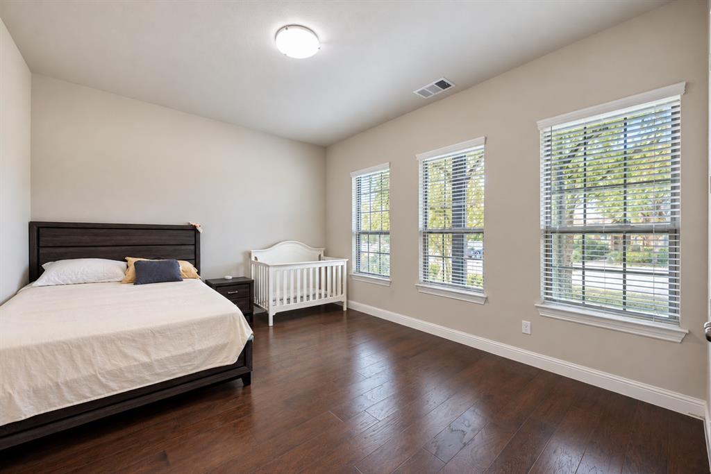 Rich wood-finish flooring complements neutral wall tones