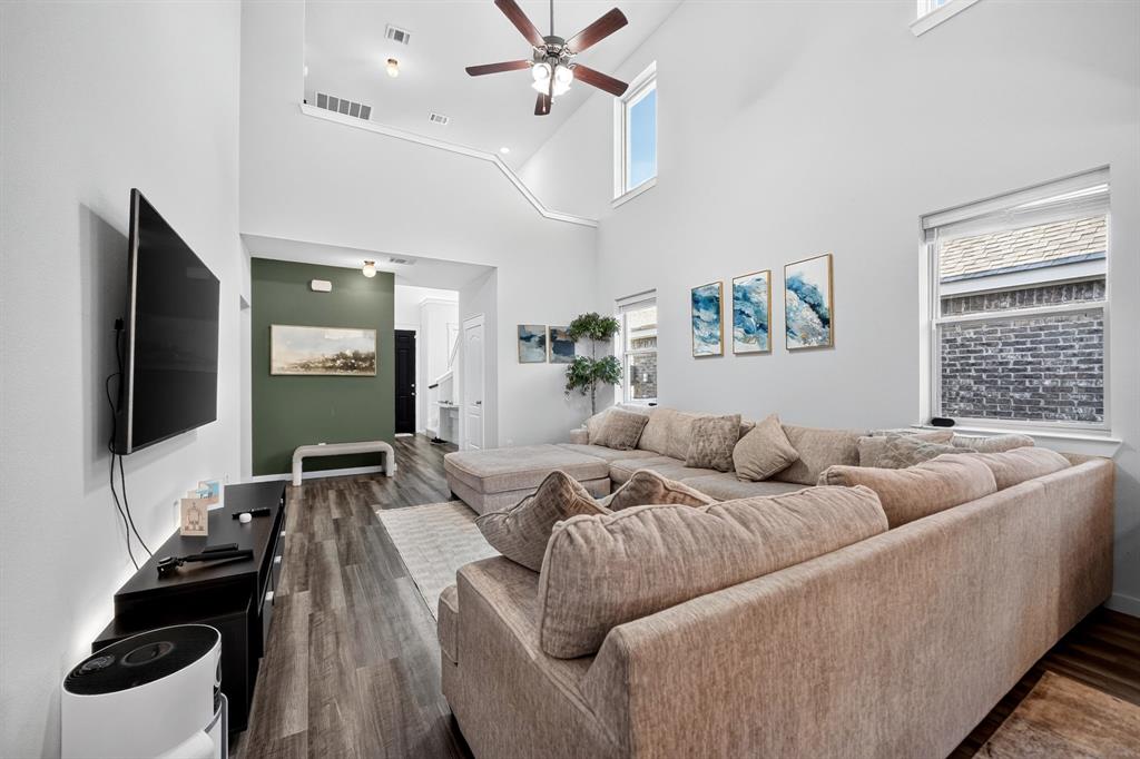 Open-concept living space featuring a ceiling fan, recessed lighting, and expansive wood-finish flooring throughout