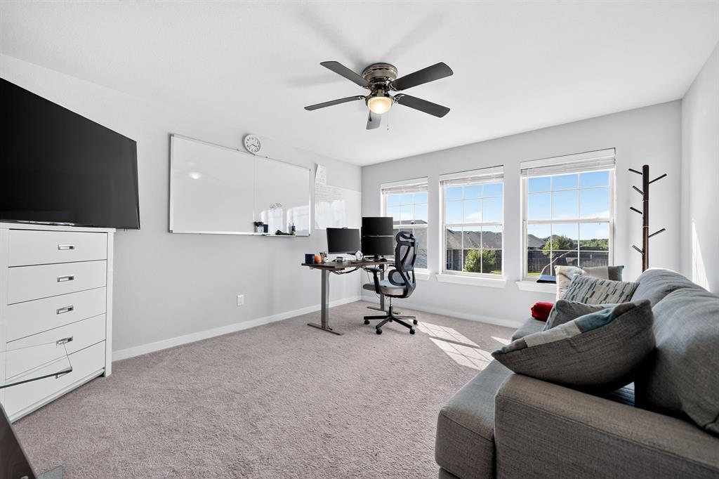 Recessed lighting, ceiling fan with integrated lighting, three large windows, and carpet flooring