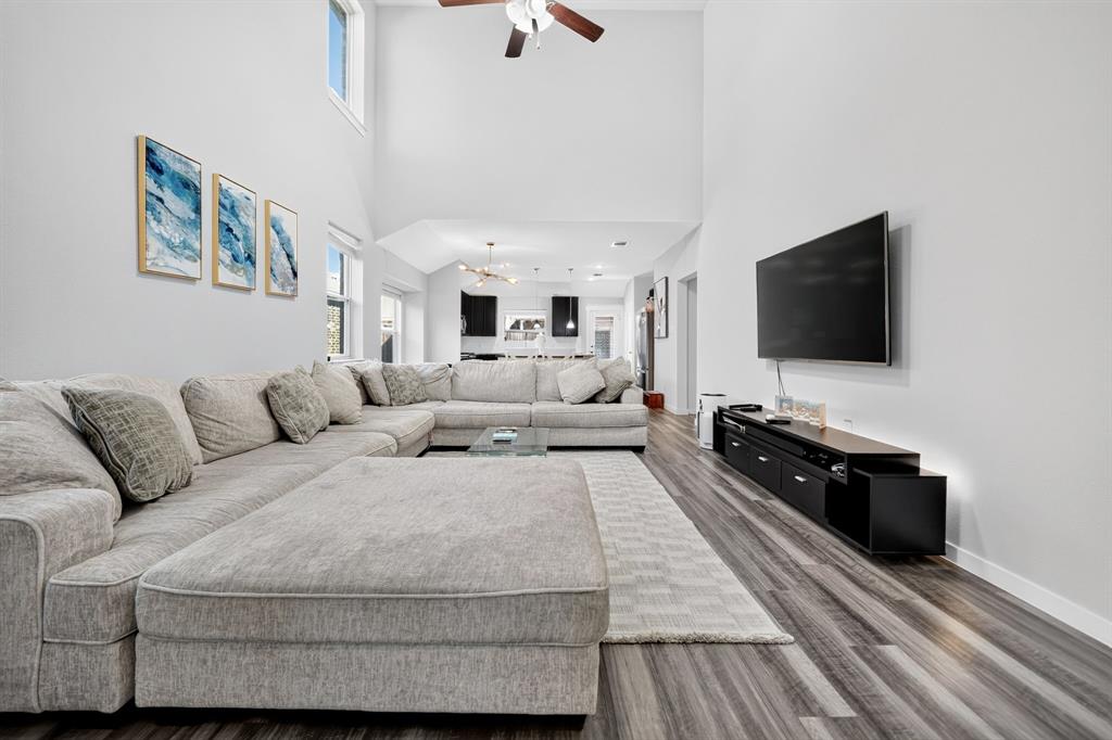 Vaulted ceilings, wood-finish flooring, and a ceiling fan