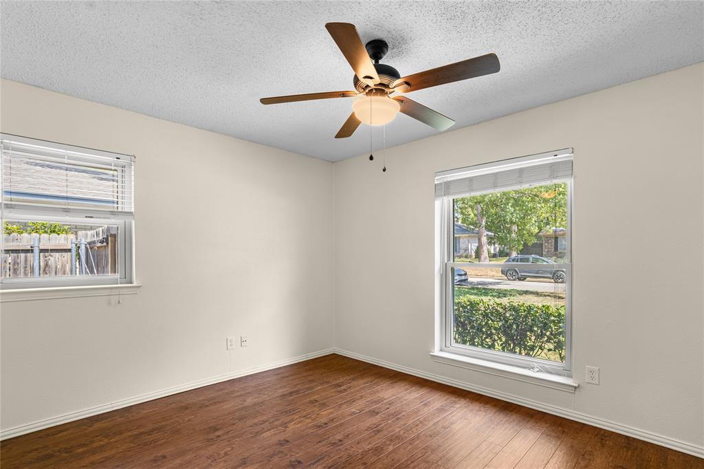 Wood-finish flooring with a ceiling fan light fixture