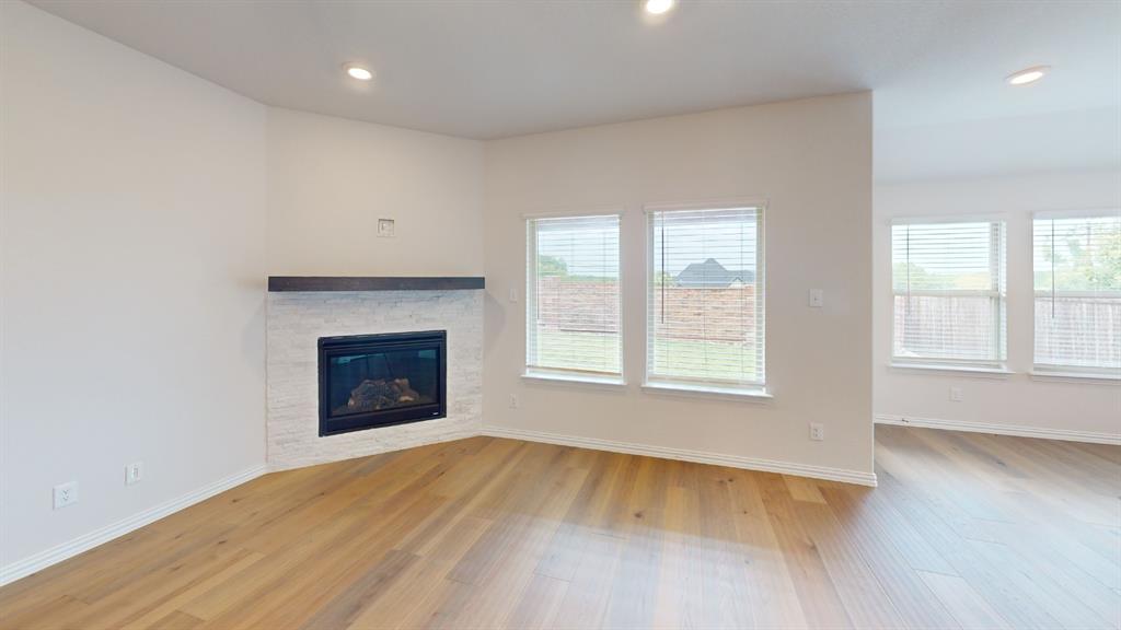 Corner fireplace with a stone surround and wood mantel Corner fireplace with a stone surround and wood mantel