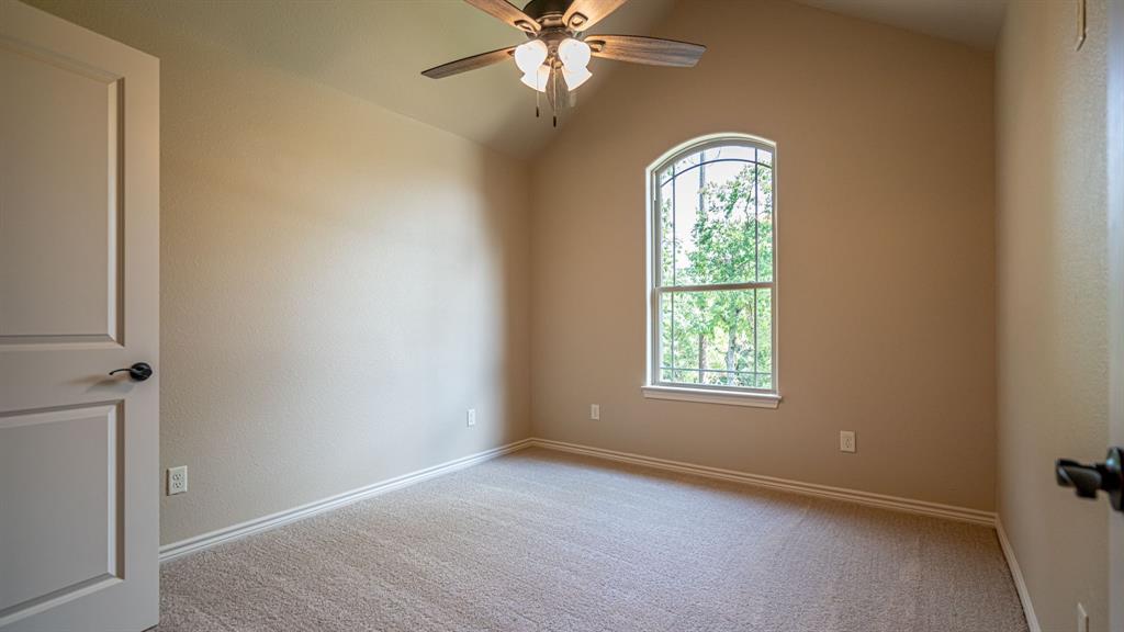 Secondary bedroom with carpet and ceiling fan