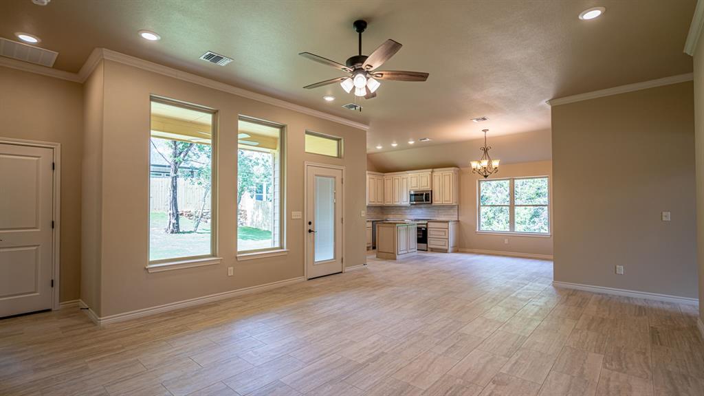 View from living area into kitchen showing back door onto patio