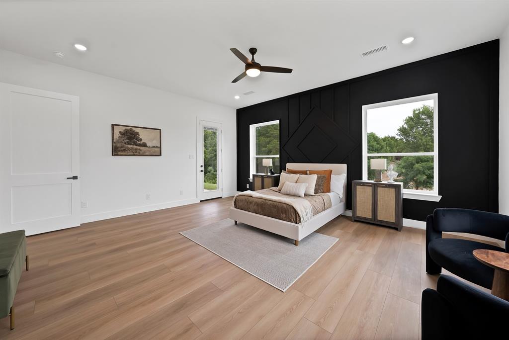 Expansive wood-finish flooring, recessed lighting, and a ceiling fan
