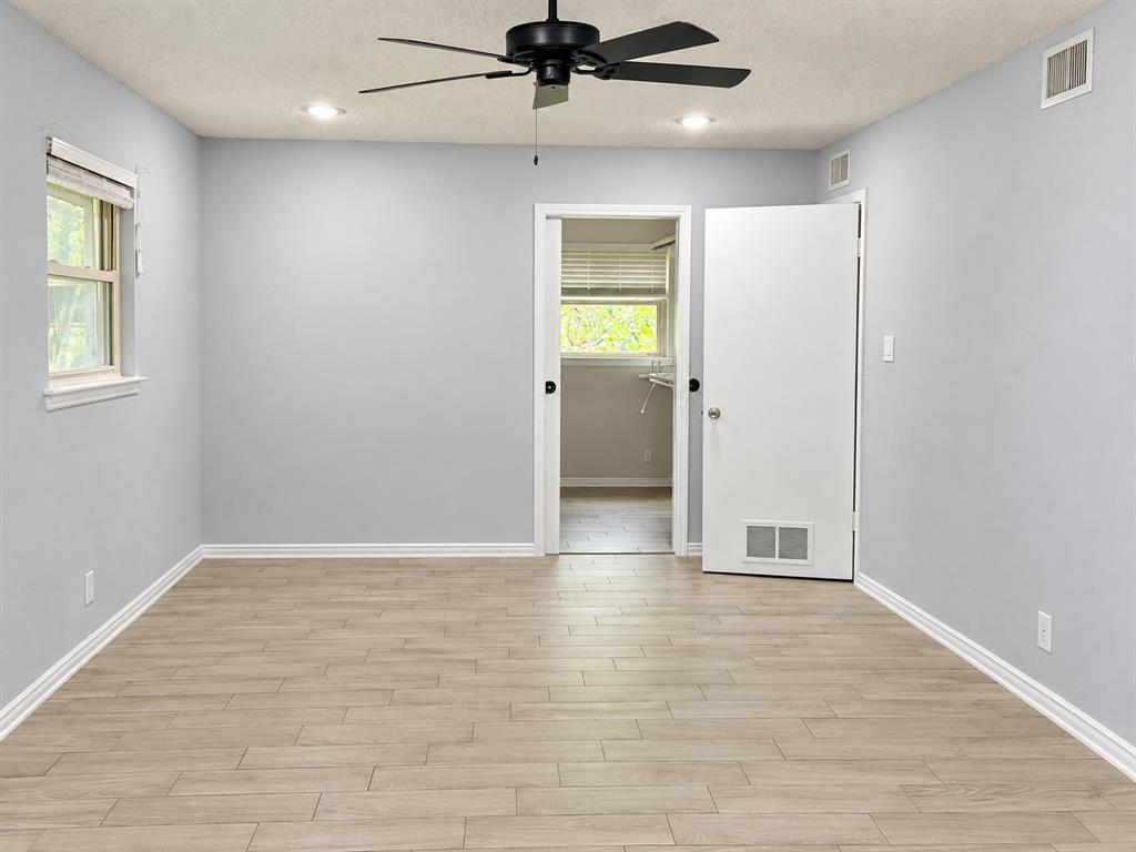 Room featuring wood-finish flooring, recessed lighting, and a black ceiling fan