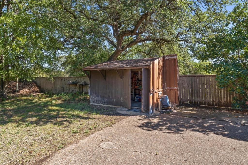 Outdoor storage shed with a shingle roof and wood siding