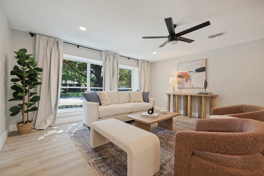 Recessed lighting, wood-finish flooring, multiple large windows, and a ceiling fan