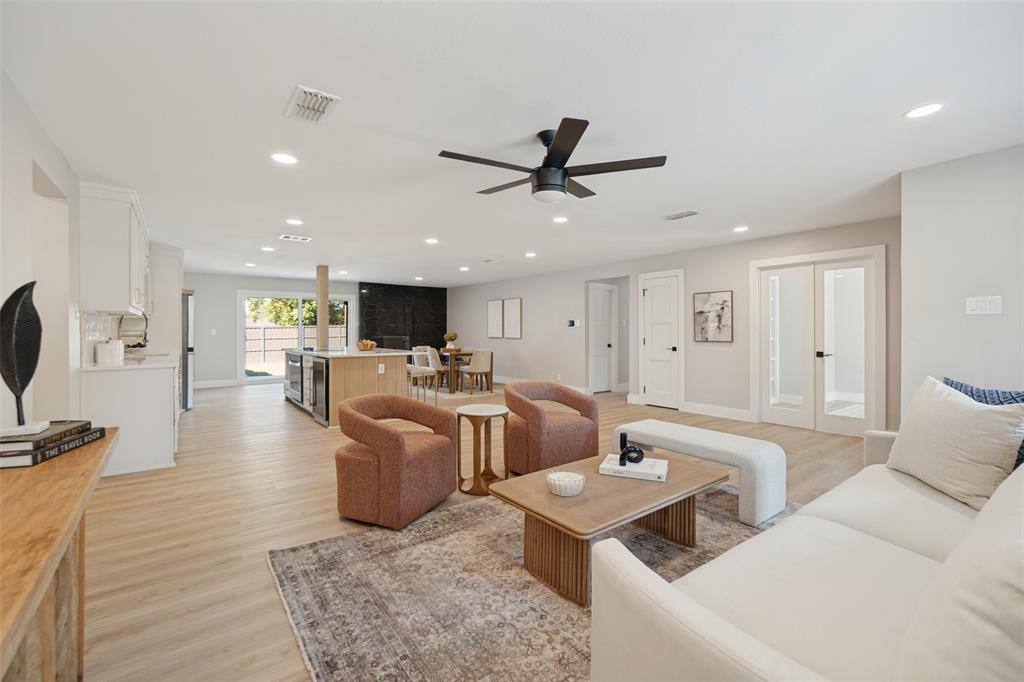 Open-concept living area featuring wood-finish flooring, recessed lighting, and a contemporary ceiling fan