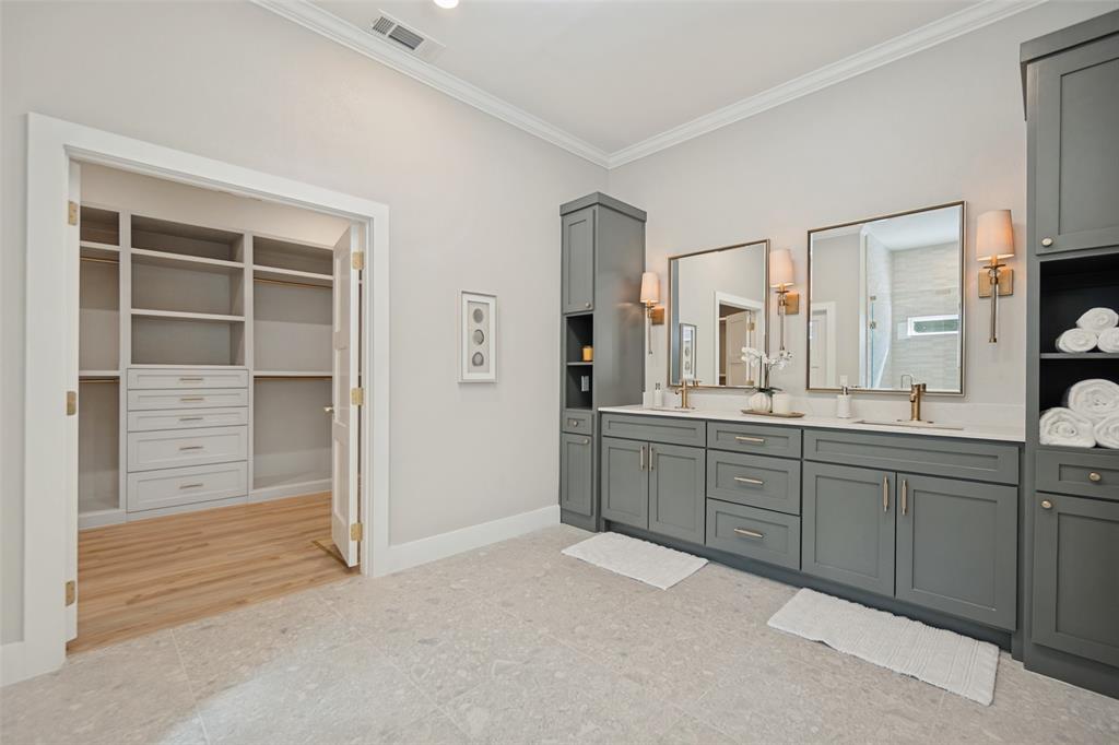 Dual vanity with integrated sinks, framed mirrors, and wall-mounted sconces