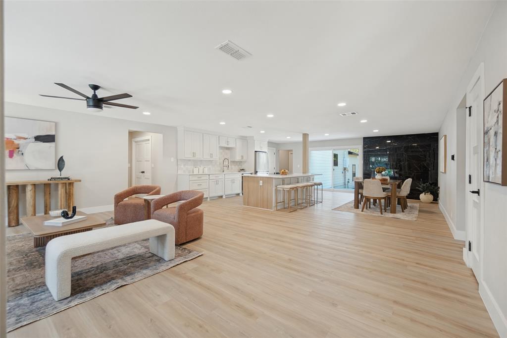 Open-concept living space featuring wood-finish flooring, recessed lighting, and a modern ceiling fan