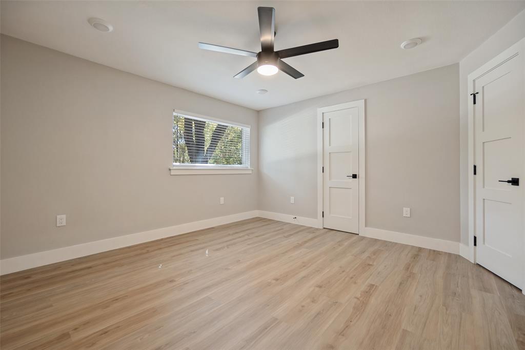 Light wood-finish flooring, neutral wall paint, and white trim throughout