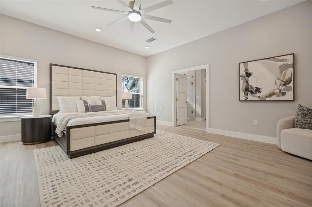 Light wood-finish flooring, recessed lighting, ceiling fan, and white trim throughout