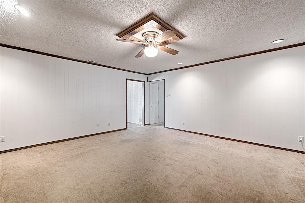 Interior space featuring wall-to-wall carpeting, recessed ceiling lighting, a wood-trimmed ceiling fan, and crown molding