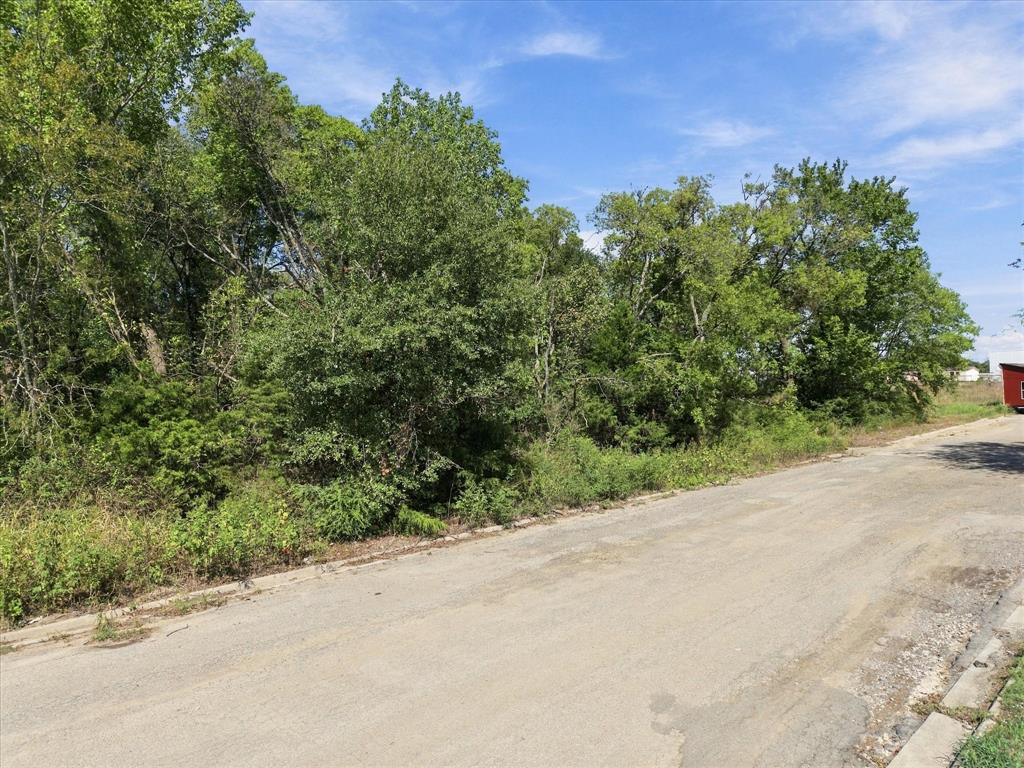 Mature trees line this almost 8 acre parcel