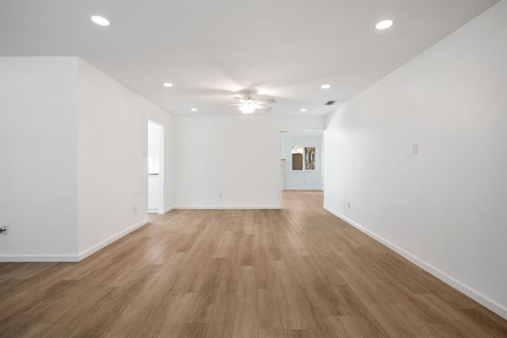 Open interior space featuring wood-finish flooring, recessed lighting, and a central ceiling fan