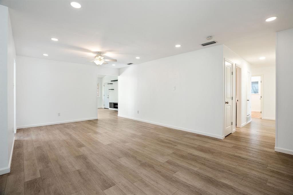 Open interior featuring wood-finish flooring, recessed lighting, and a neutral color palette