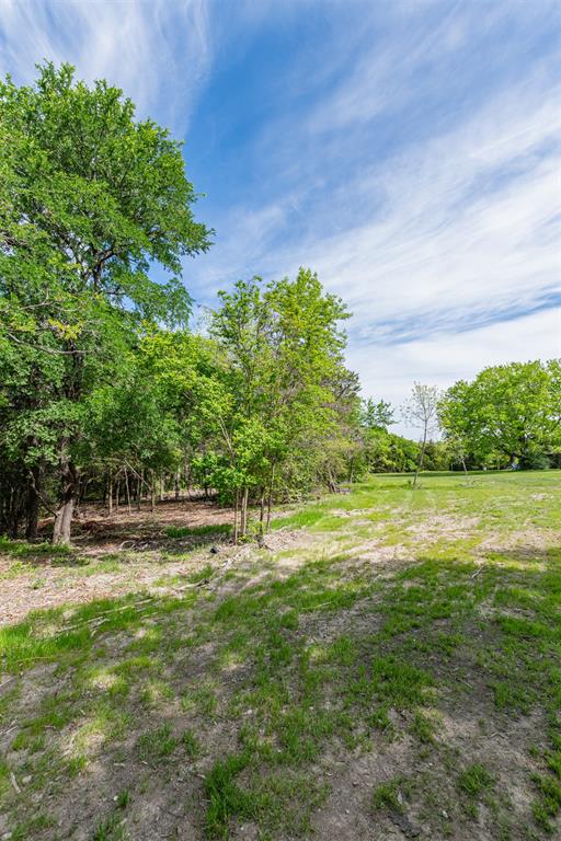 Expansive pastoral setting with mature shade trees and open grounds