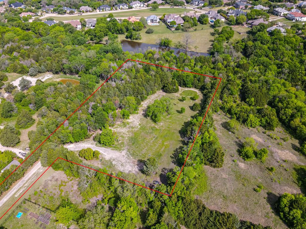 Expansive treed lot with varied terrain, including open clearings and dense foliage