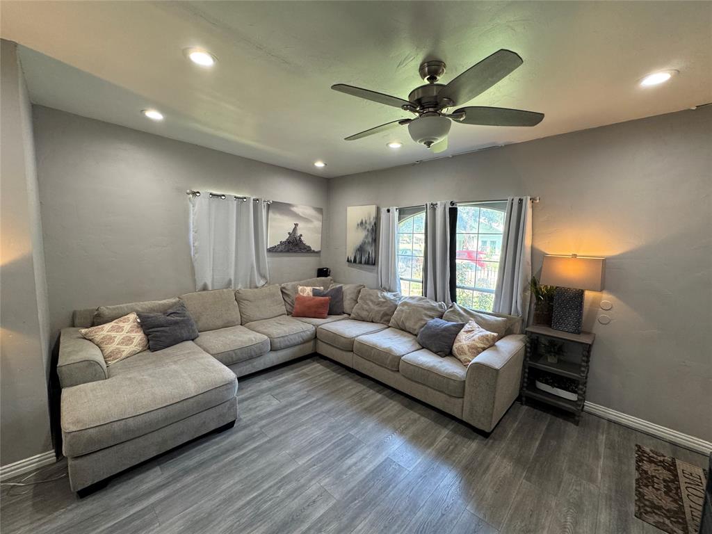 Living area with dark wood-style flooring, recessed lighting, and ceiling fan