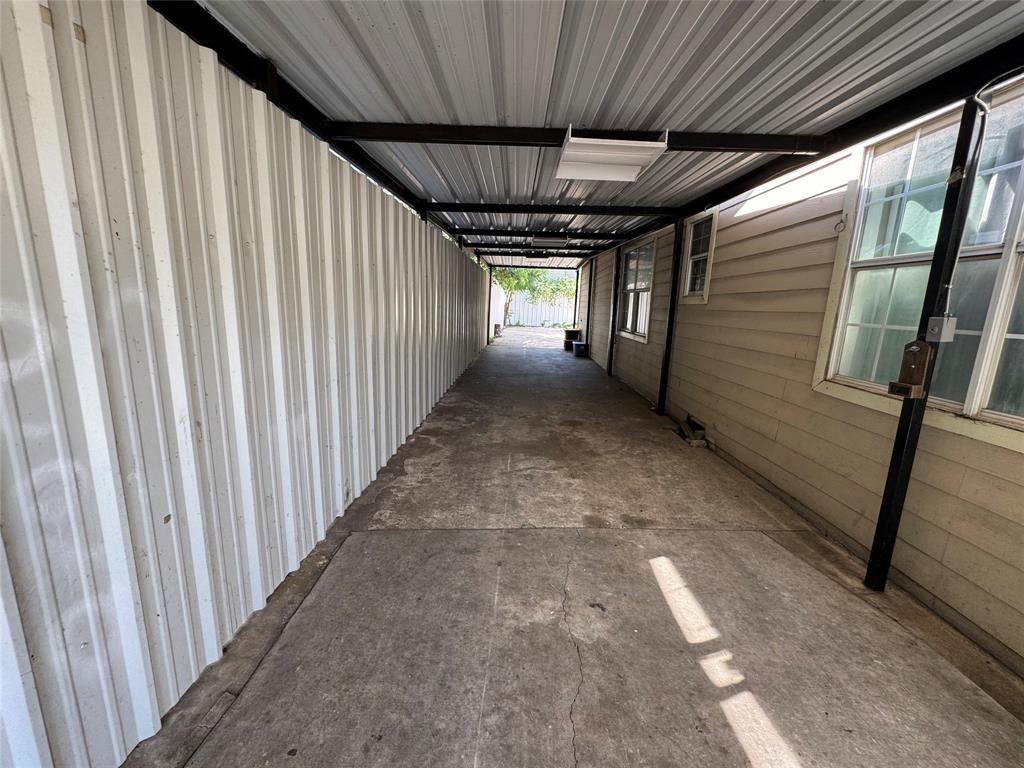 Hallway featuring metal wall