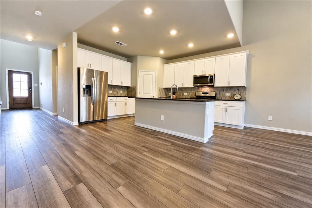 Open concept living area with wood-finish flooring