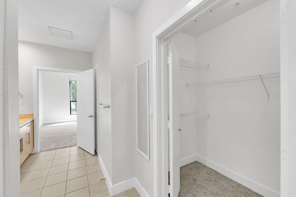 Recessed closet with wire shelving and carpeted flooring