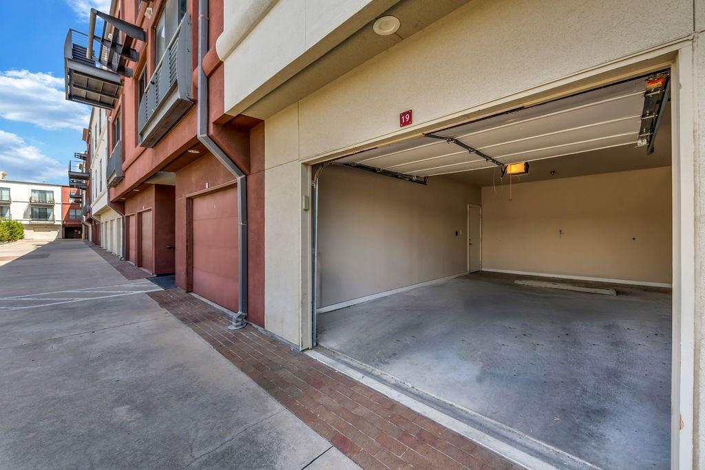 Spacious garage with concrete flooring, automatic garage door opener, and interior access door